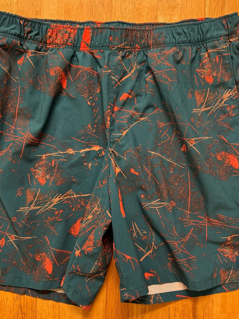 The North Face Teal Athletic Shorts with Orange Print
